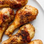 A plate of crispy air fryer chicken legs on a plate.