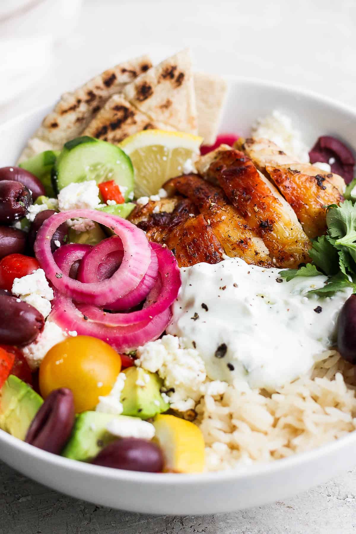 Another view of the Greek chicken bowl that has all the toppings.