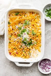Street corn dip in a white baking dish after cooking in the oven.