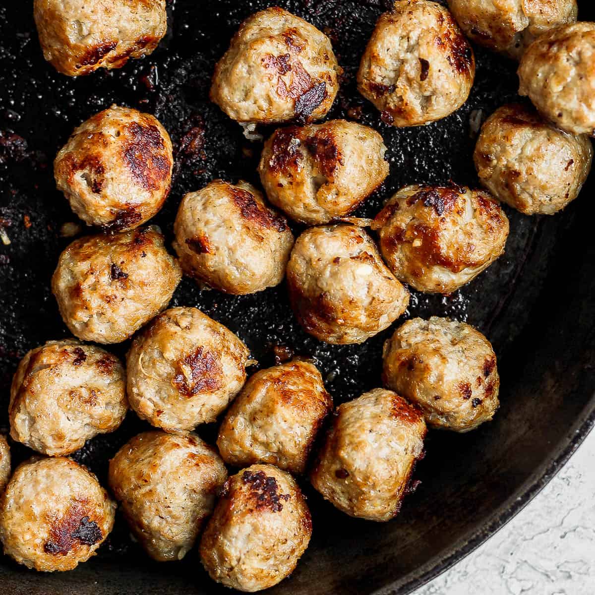 Turkey meatballs in a cast iron skillet.