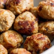 A close up shot of turkey meatballs in a bowl.