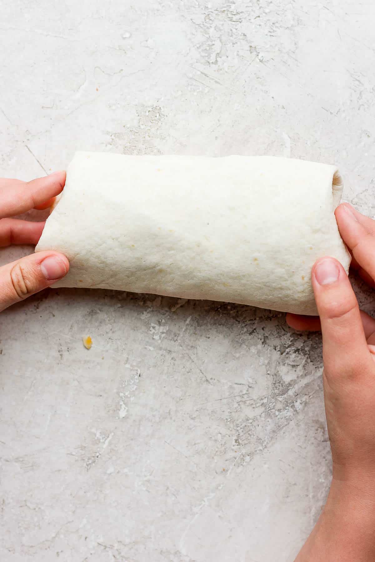 A chicken bacon ranch wrap on the counter.