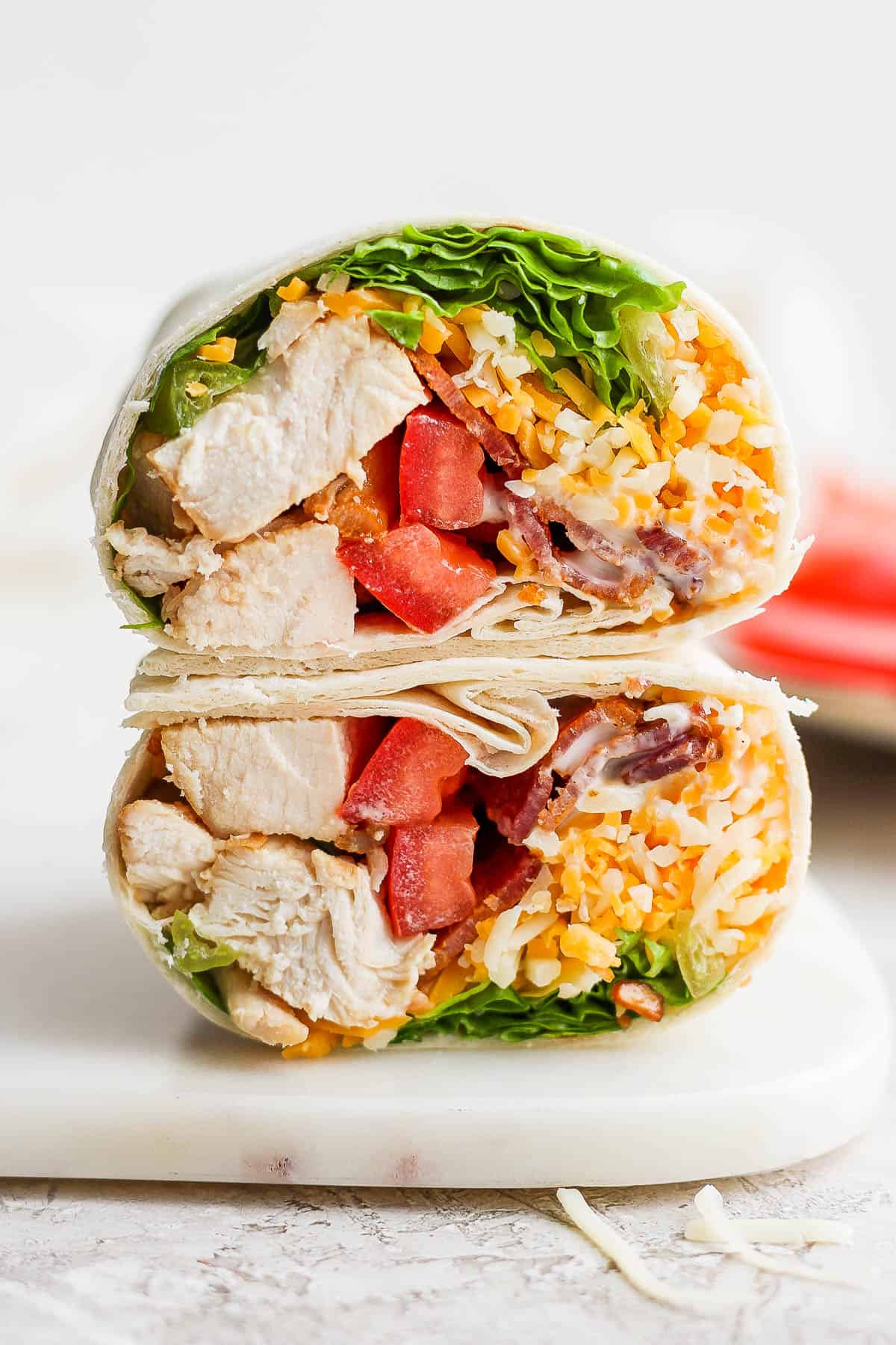 A chicken bacon ranch wrap, cut in half, and stacked on top of each other.