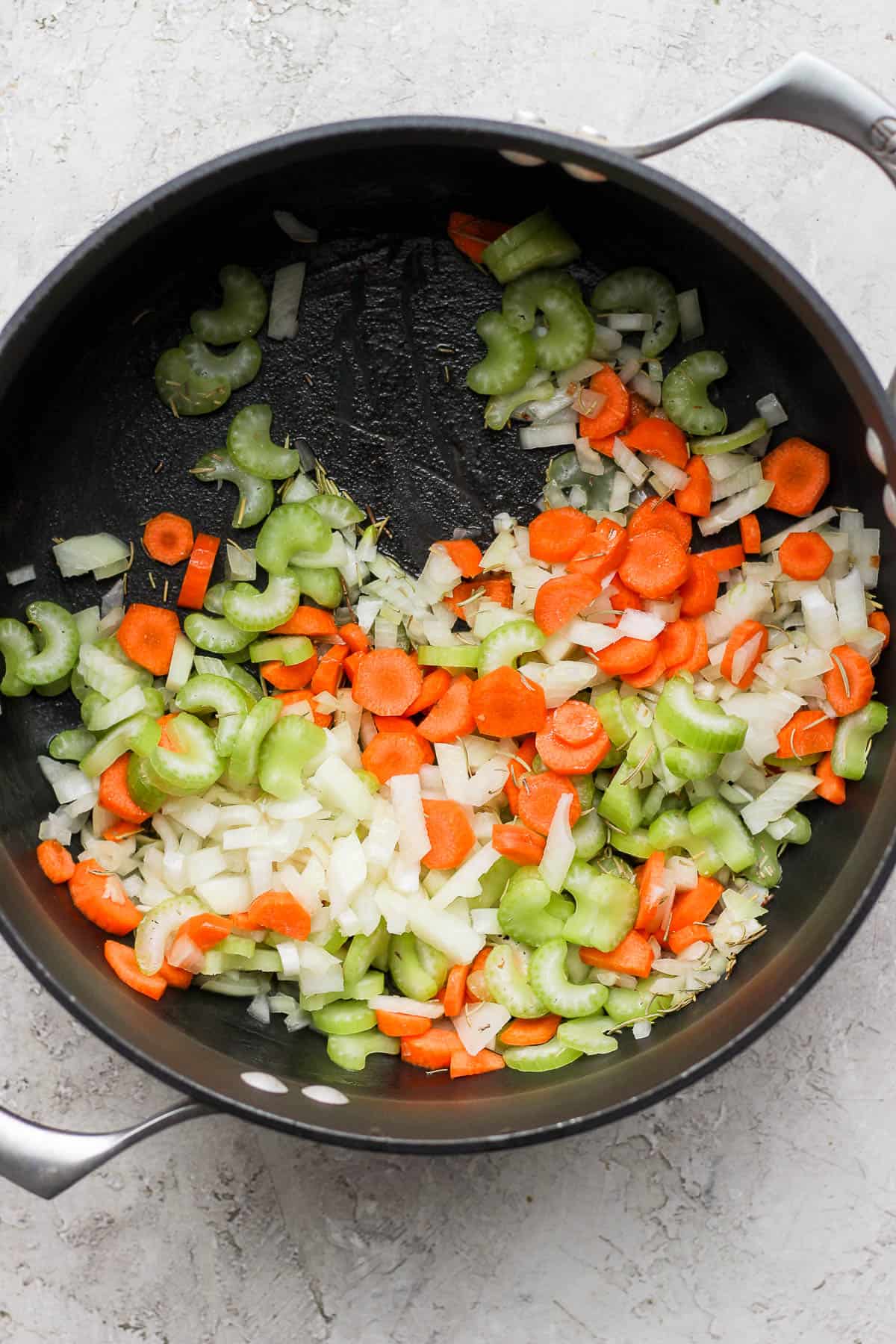 Onion, garlic, carrots, celery, & fresh herbs sautéing in the pot.