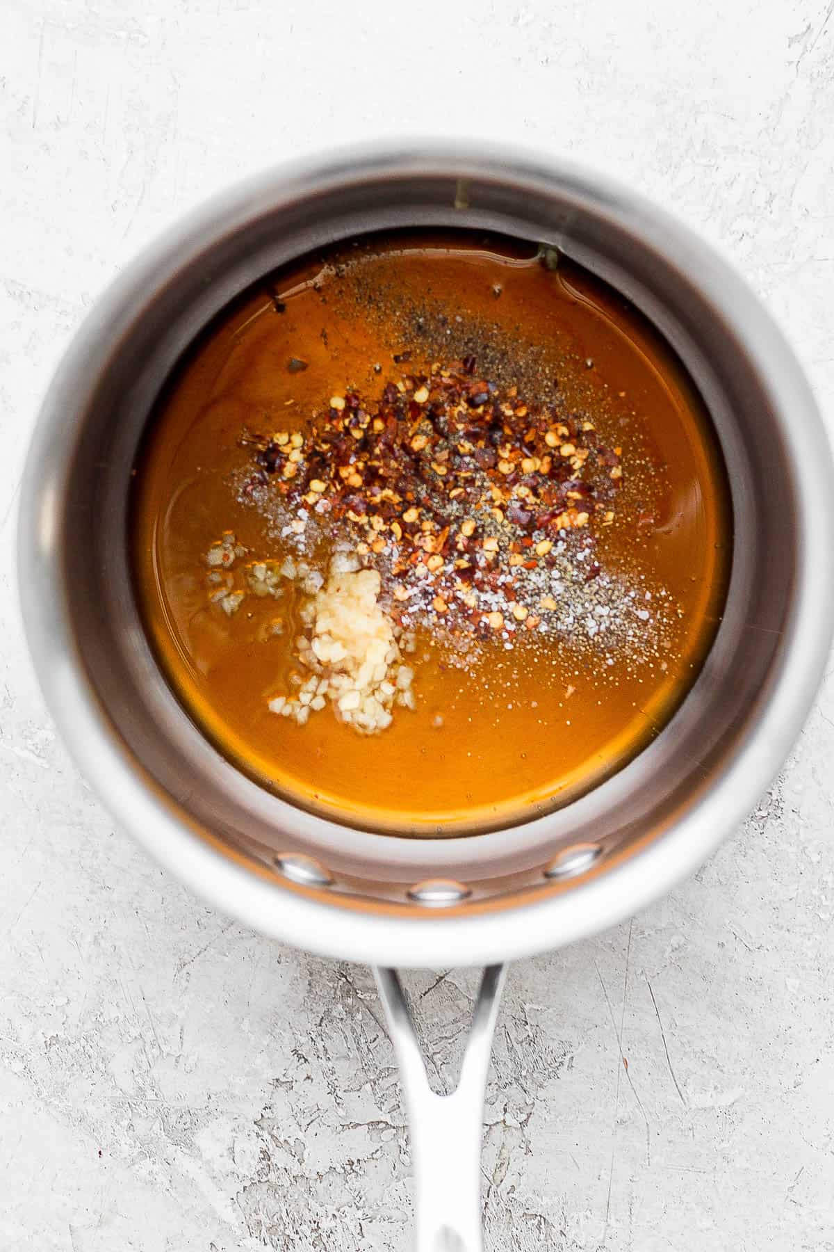 Hot honey sauce ingredients in a small sauce pan.