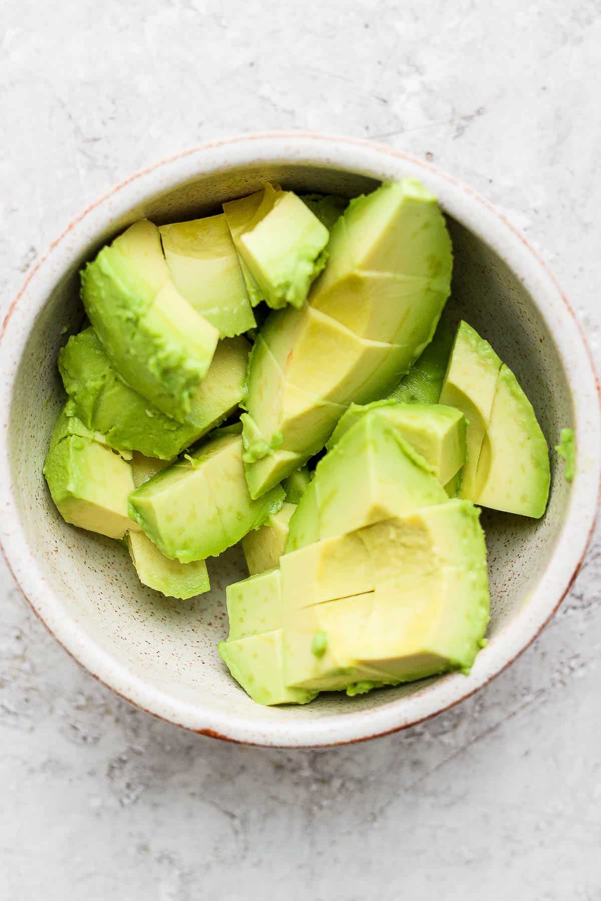 Diced avocado pieces in a small bowl.