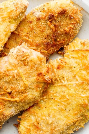 Plate of 4 baked chicken cutlets.