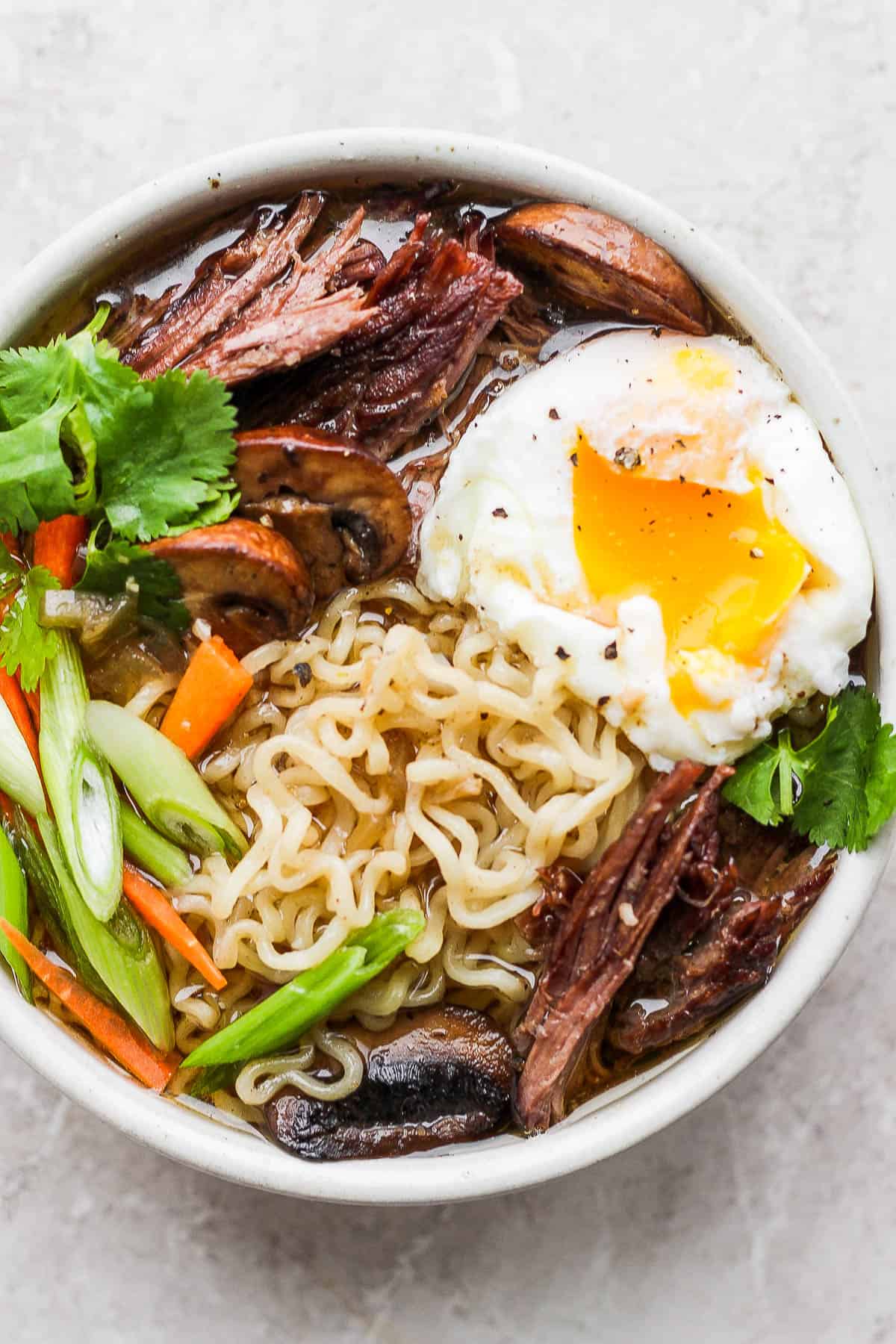 A large bowl of beef ramen with all the toppings.