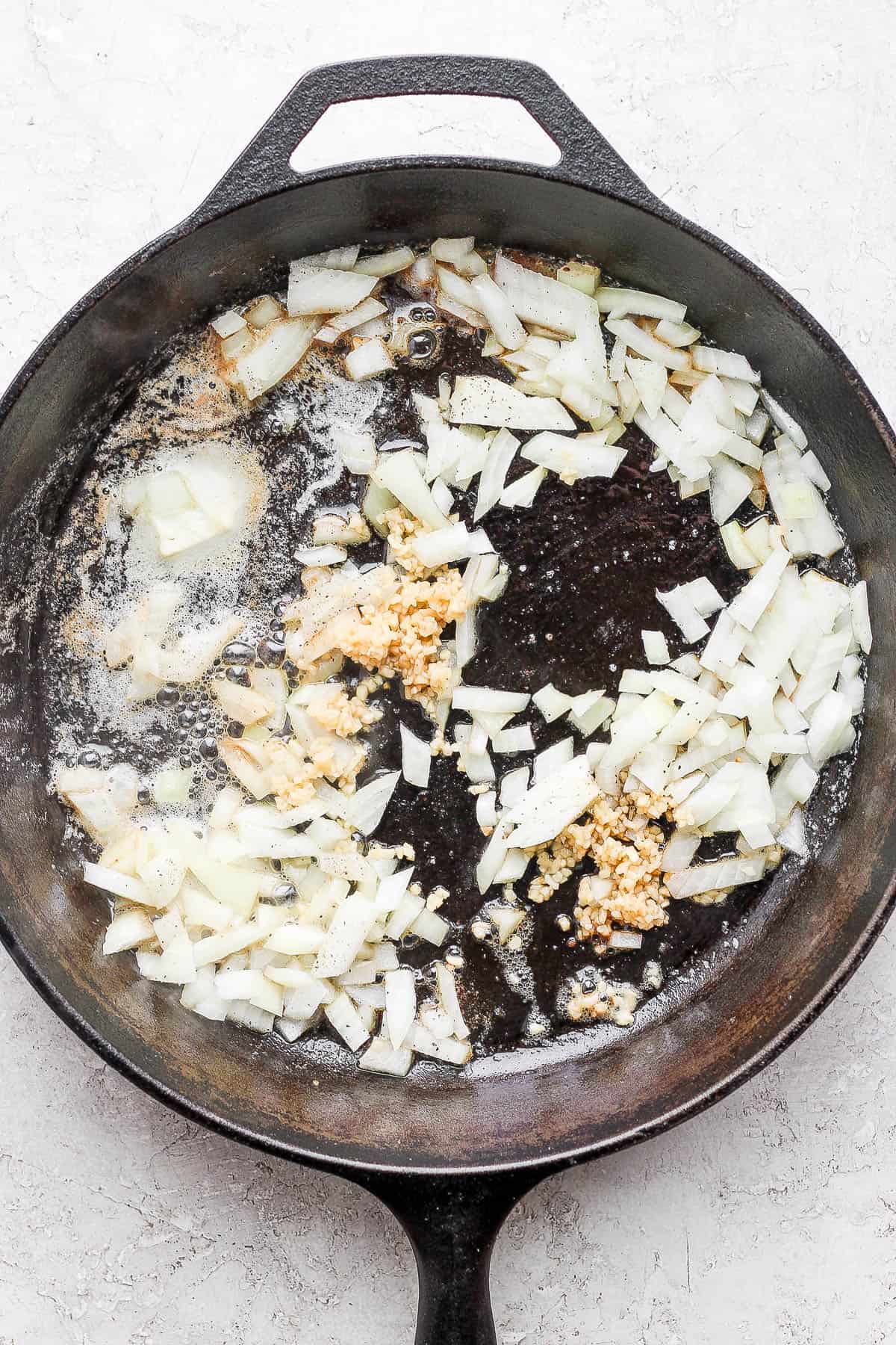 The garlic and onion being sautéed in the skillet.