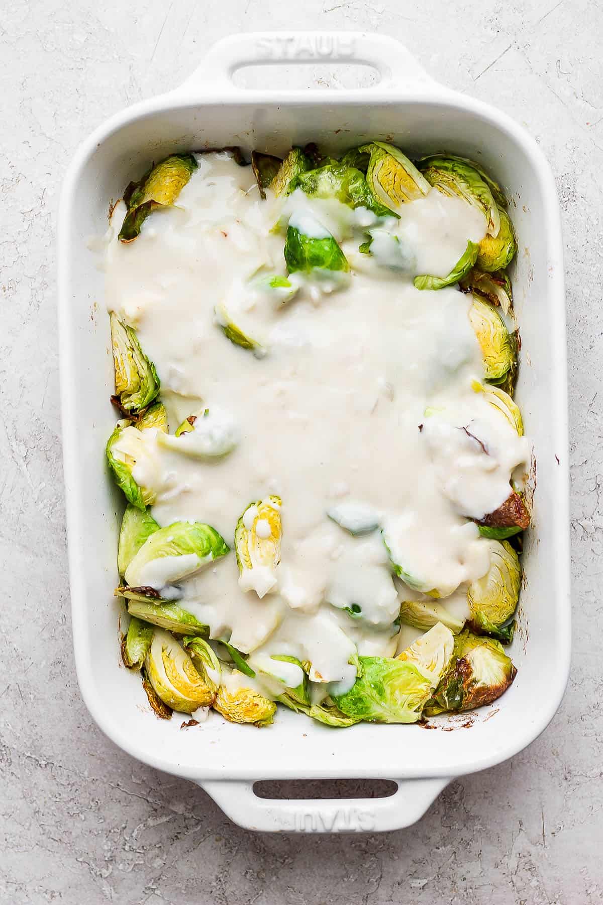 Cheese mixture poured over the top of the roasted brussels sprouts.
