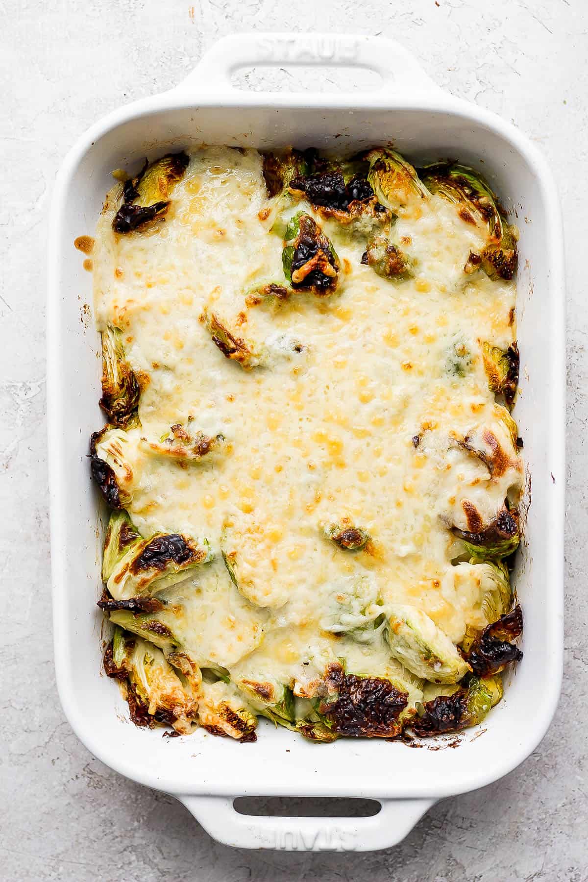 Brussels sprouts au gratin in a casserole dish.
