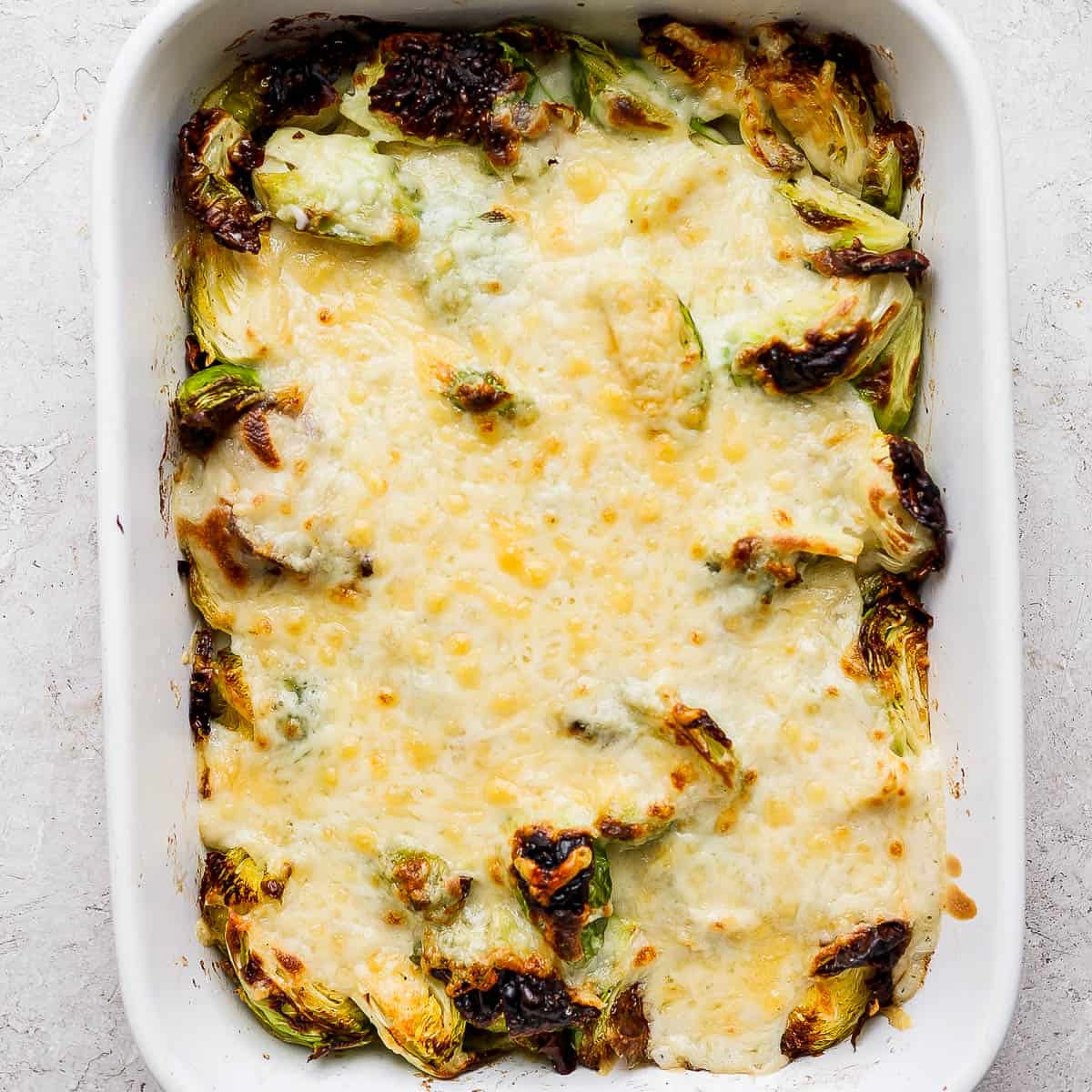 A casserole dish filled with brussel sprouts au gratin.
