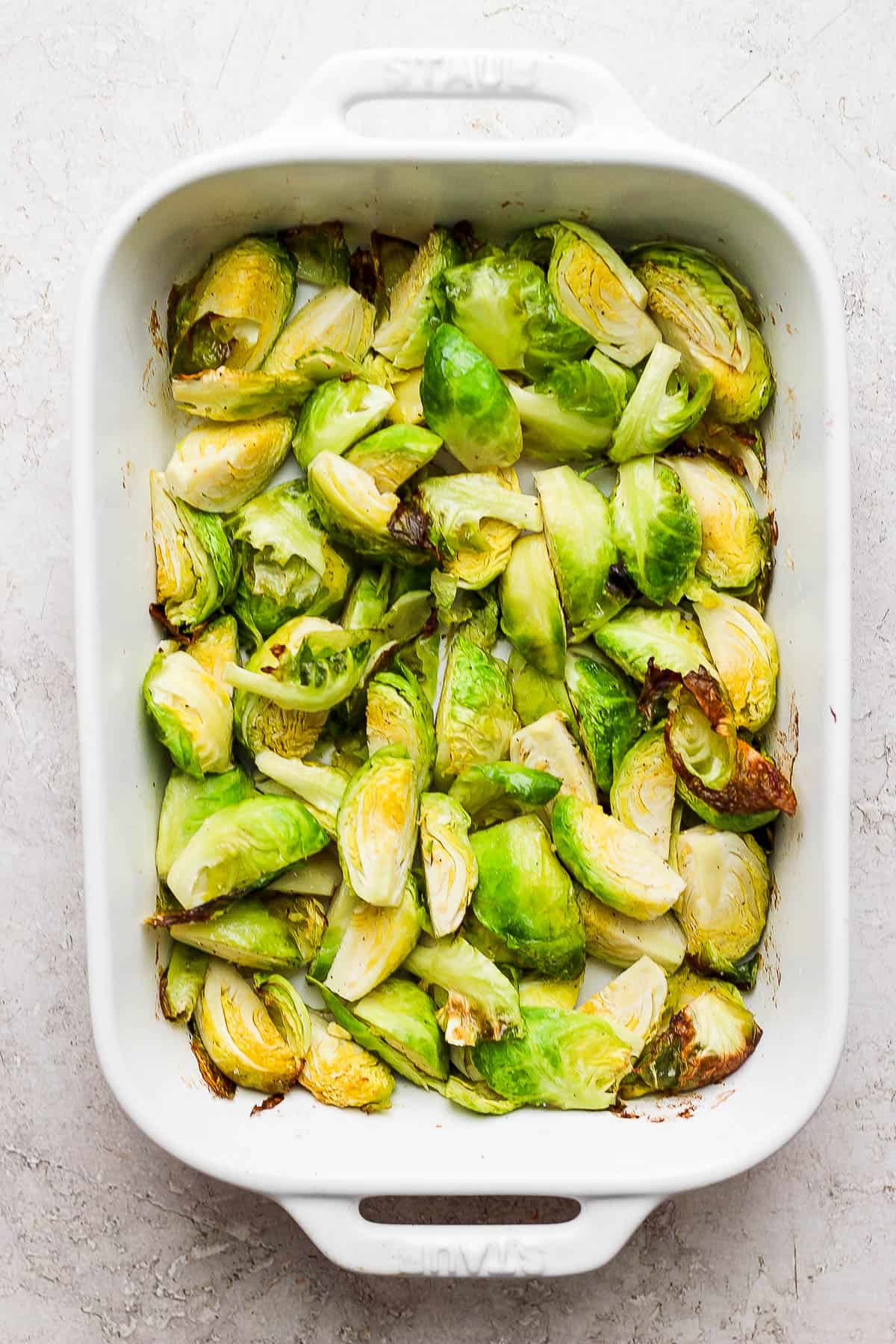 Roasted brussels sprouts in a casserole dish.