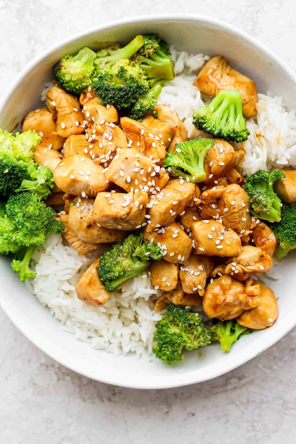 Chicken teriyaki with broccoli on top of white rice.