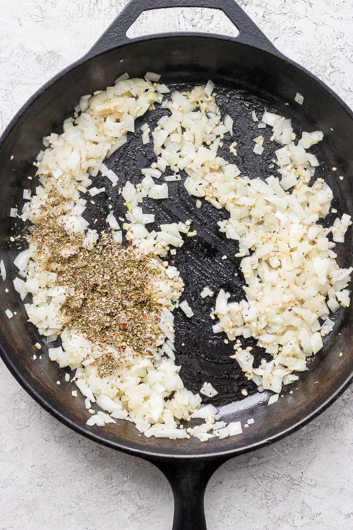 Dried seasonings added to the skillet.