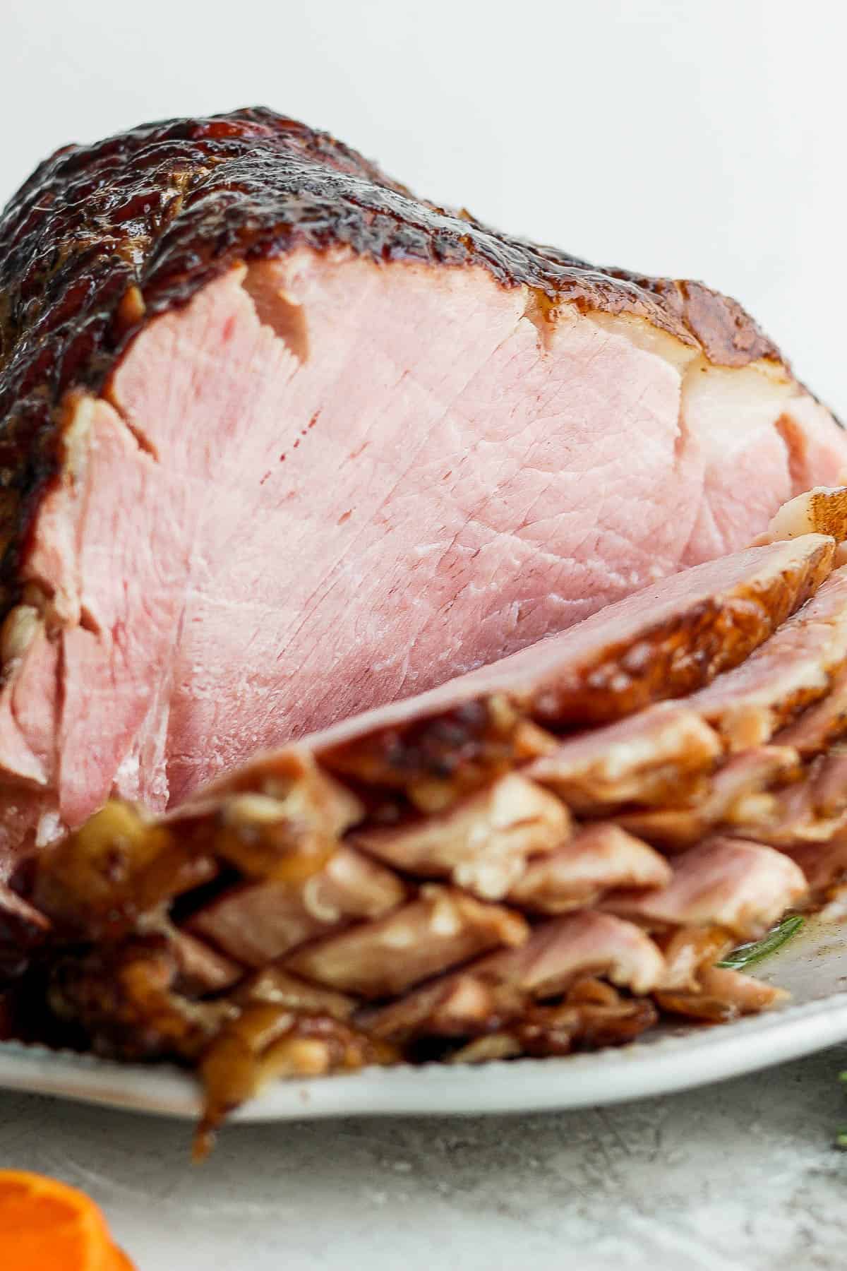 Crockpot ham carved into slices.