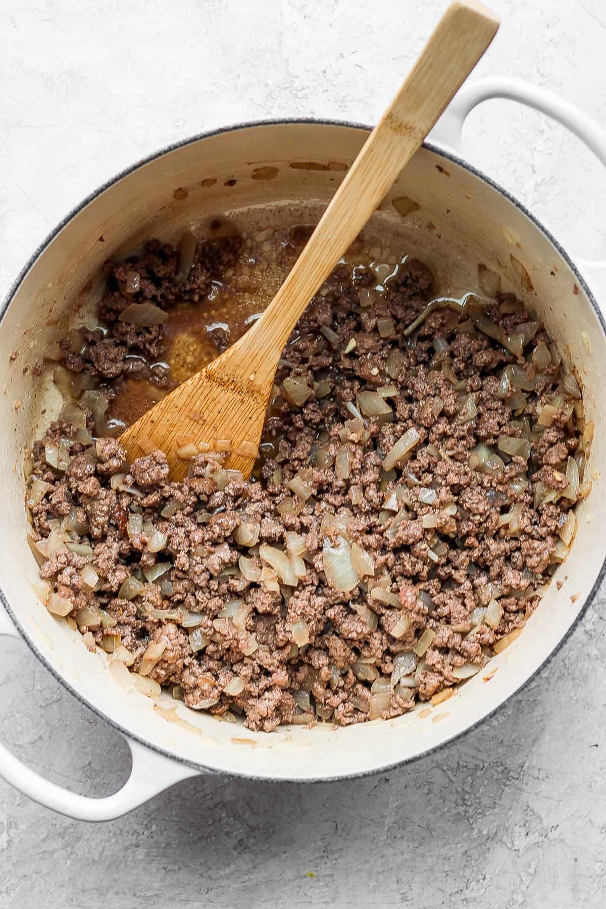Ground beef added to the onion and garlic mixture.