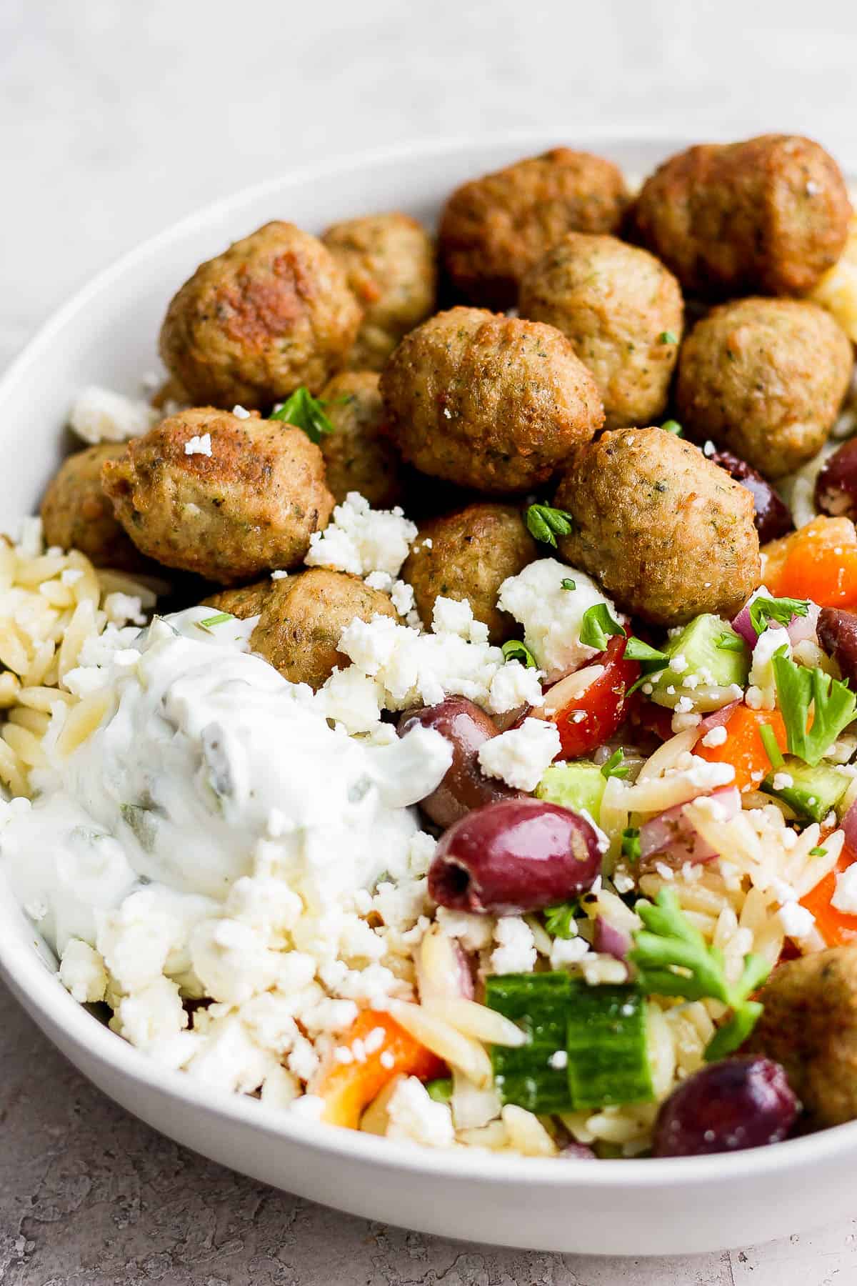 Another view of a greek turkey meatball bowl with all the toppings.