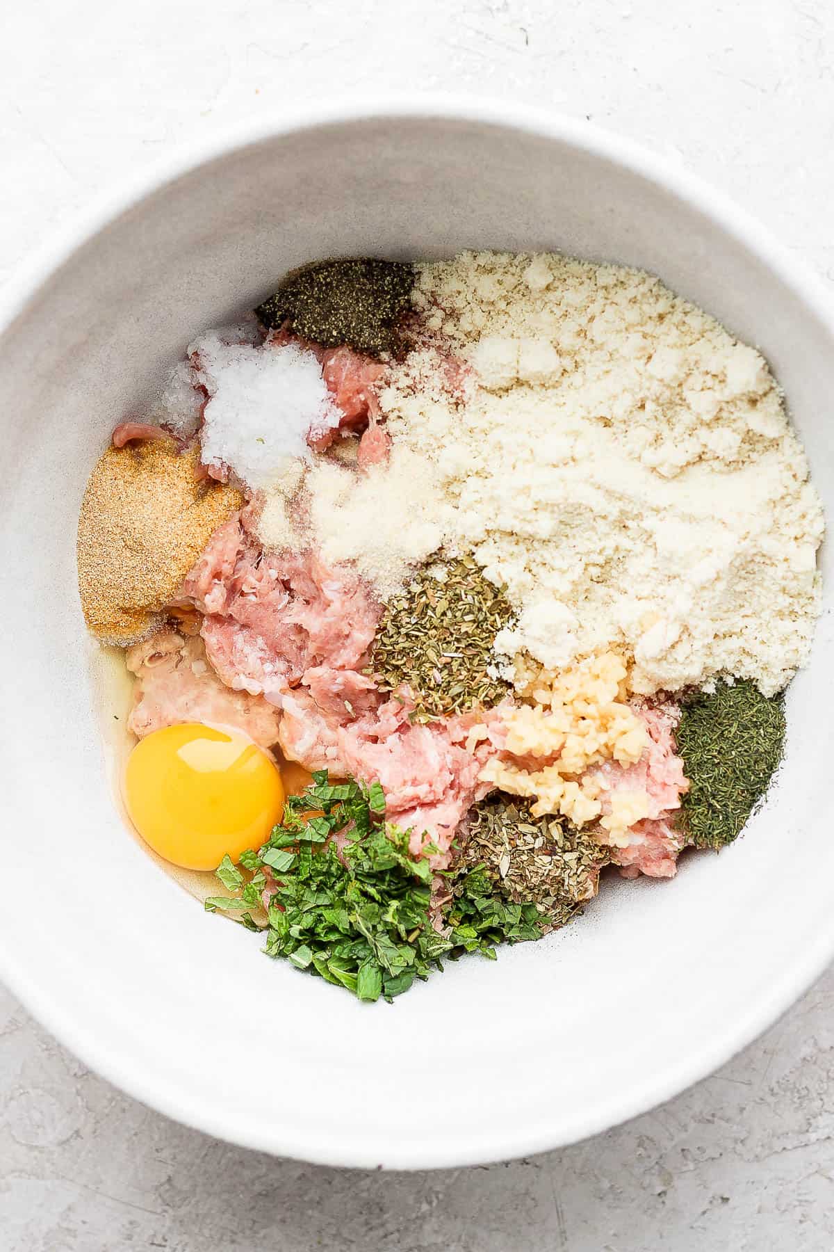 All of the meatball ingredients in a bowl.