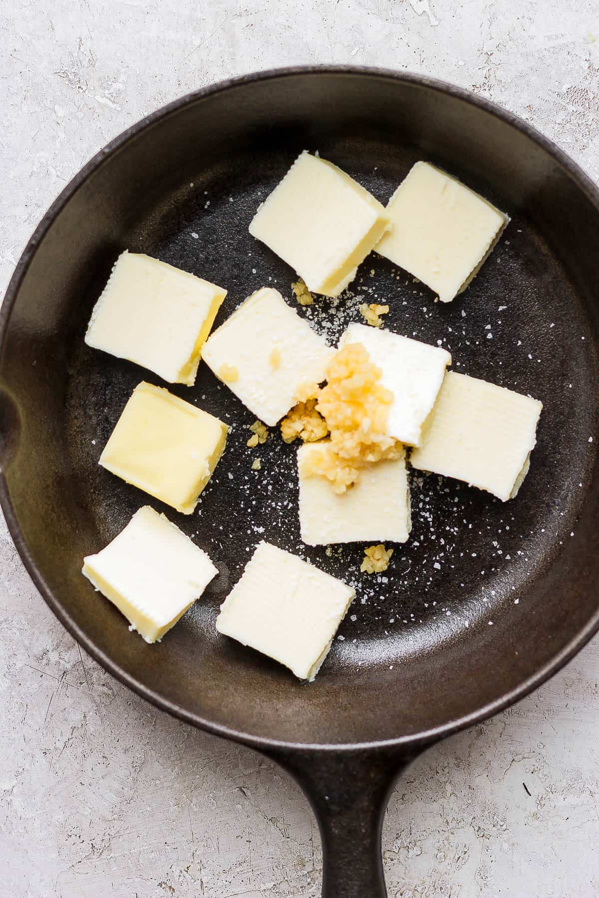 Smoked butter ingredients in a large cast iron skillet.