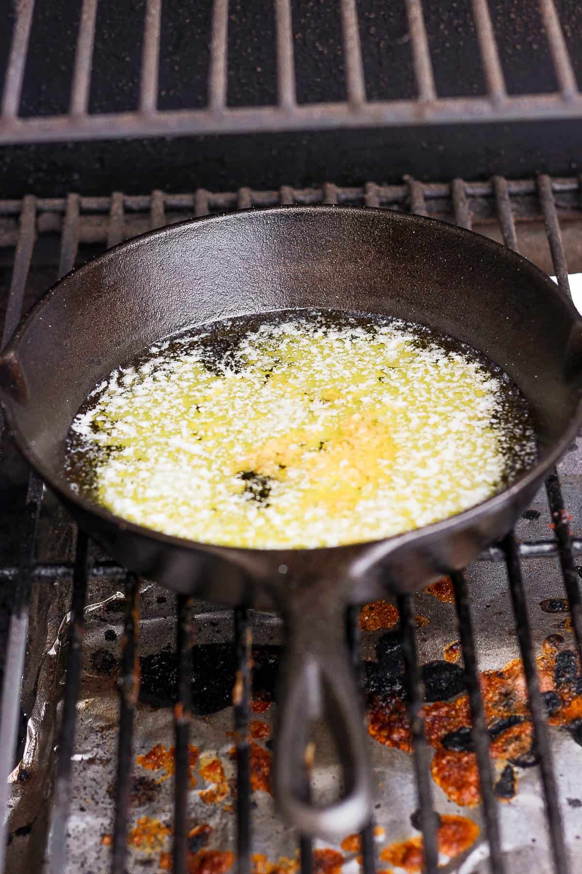 Smoked butter in a cast iron skillet on the smoker.