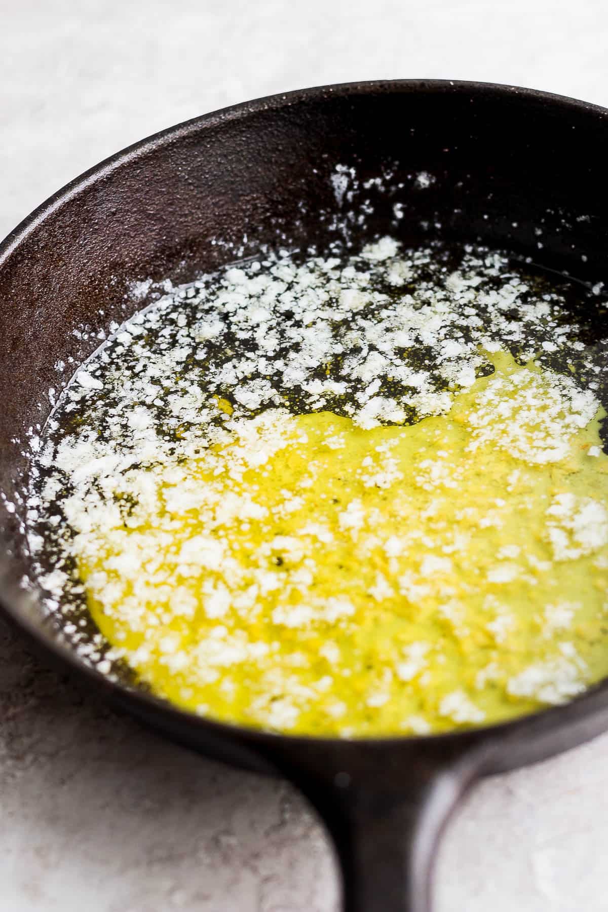 Fully melted smoked butter in a cast iron skillet.