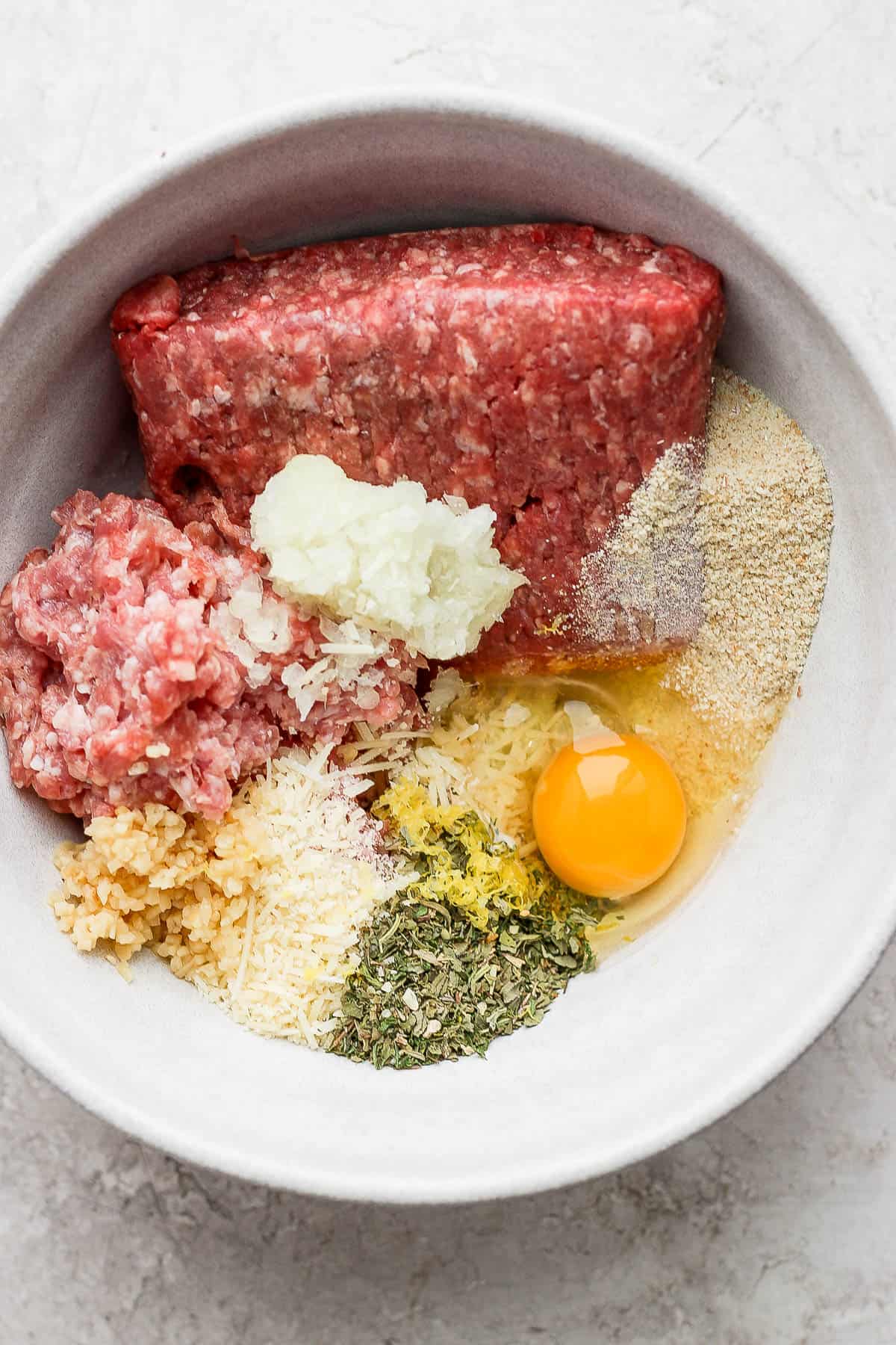 Meatball ingredients in a mixing bowl.