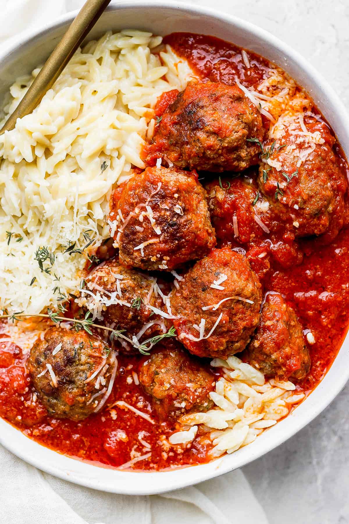 The best Italian meatball recipe with lots of marinara sauce and parmesan orzo.