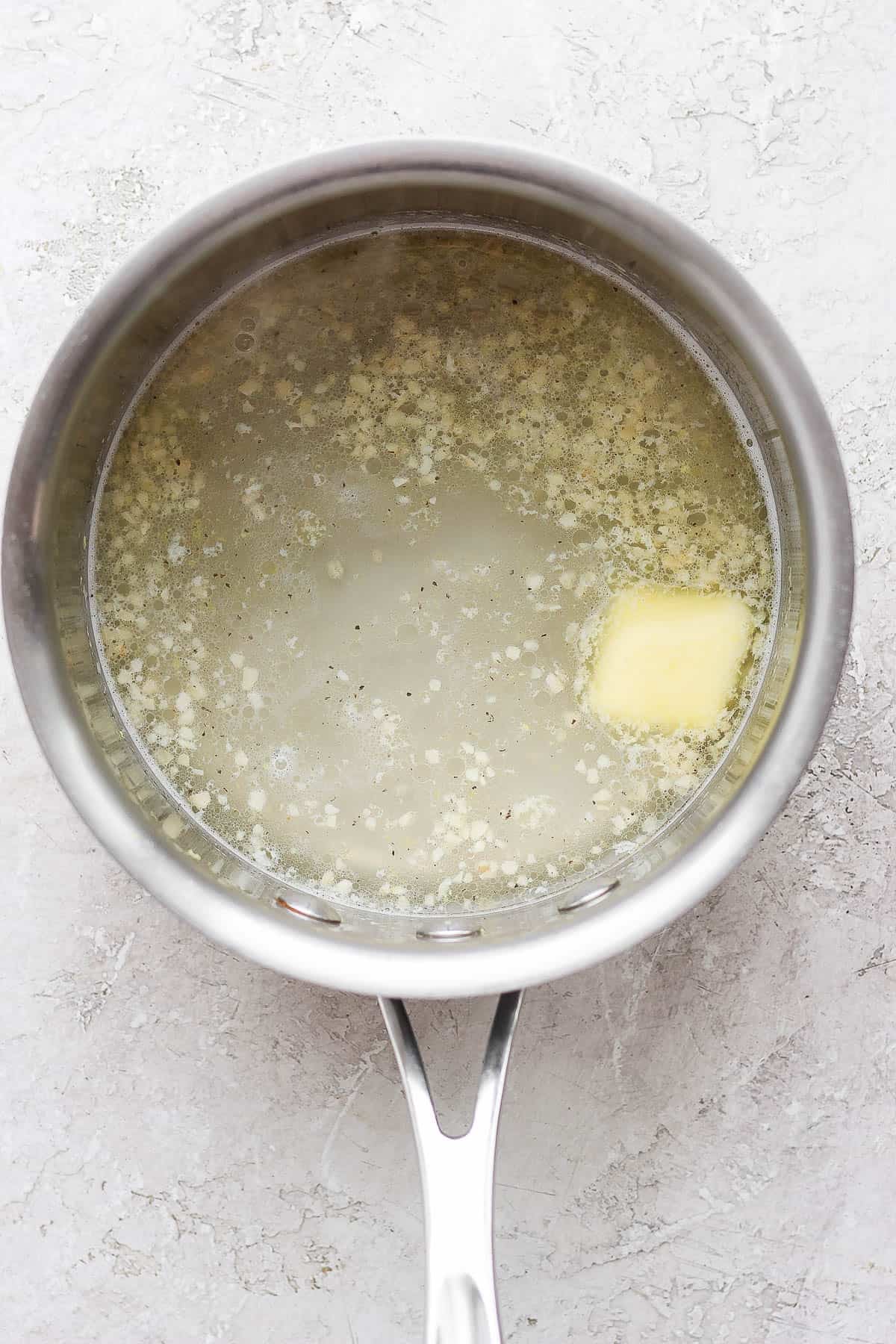 Water, butter, salt, pepper, and lemon zest added to the sauce pan.