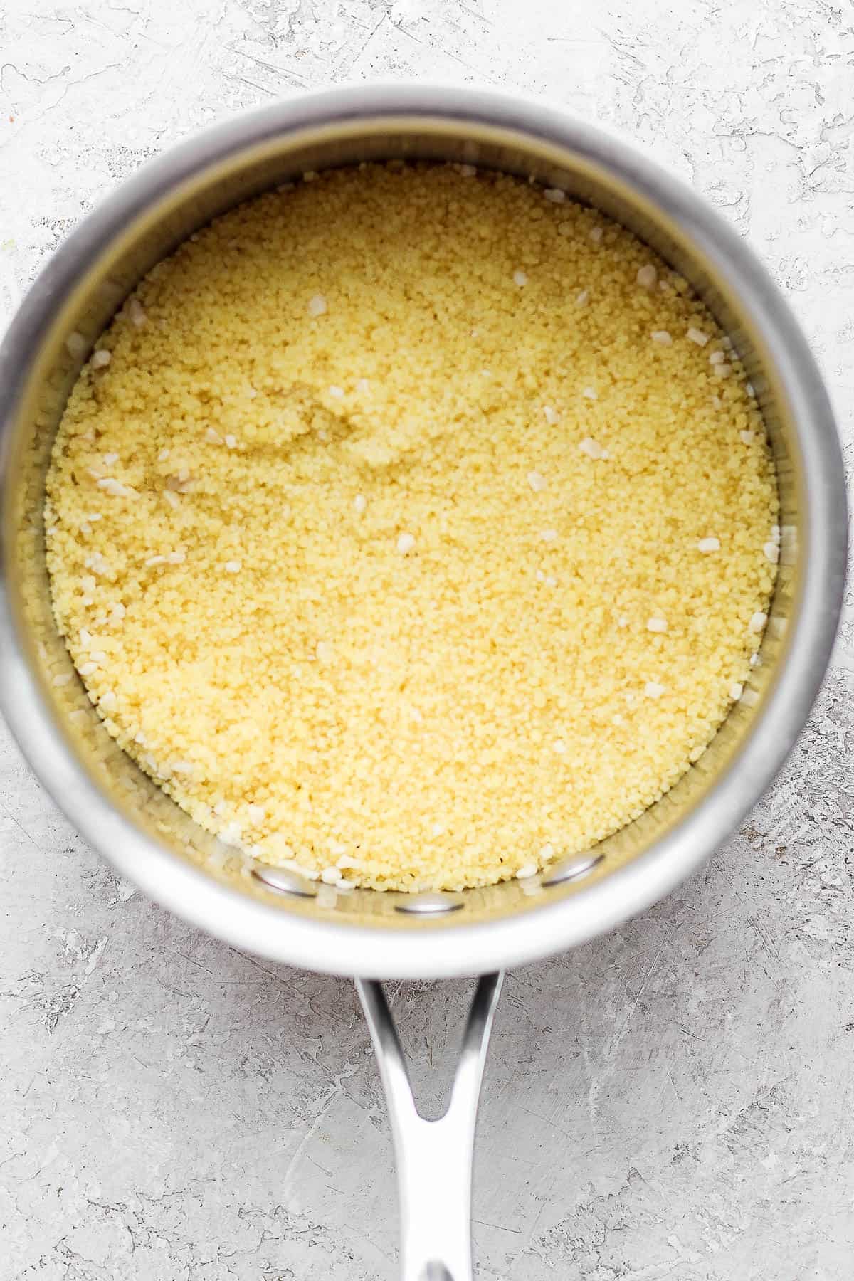 Steamed couscous in the sauce pan.