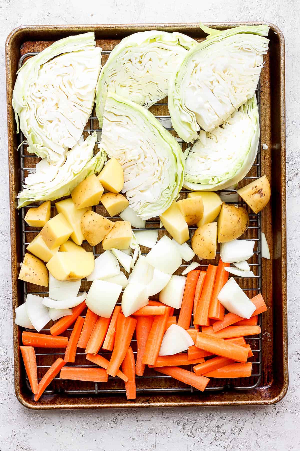 Vegetables on a wire rack on a baking sheet.