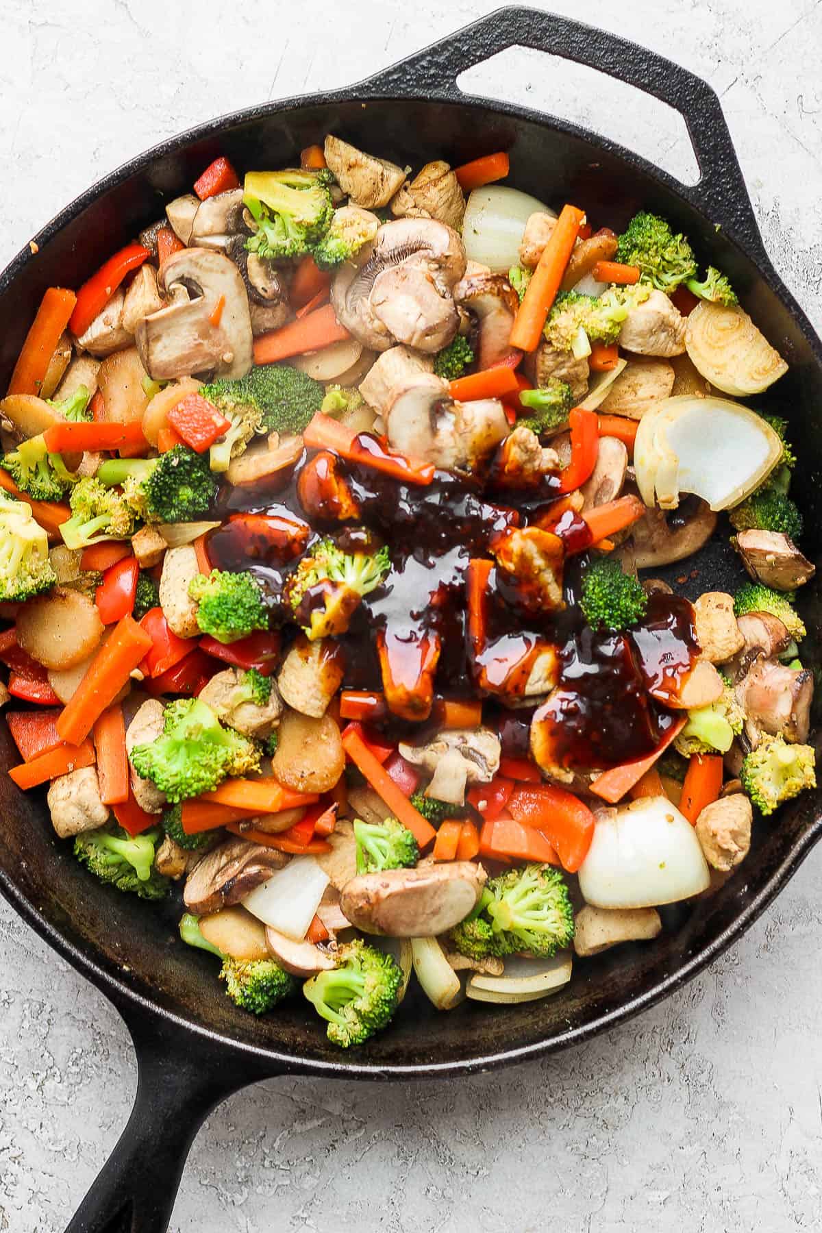 Teriyaki sauce poured on top of the chicken and veggies.
