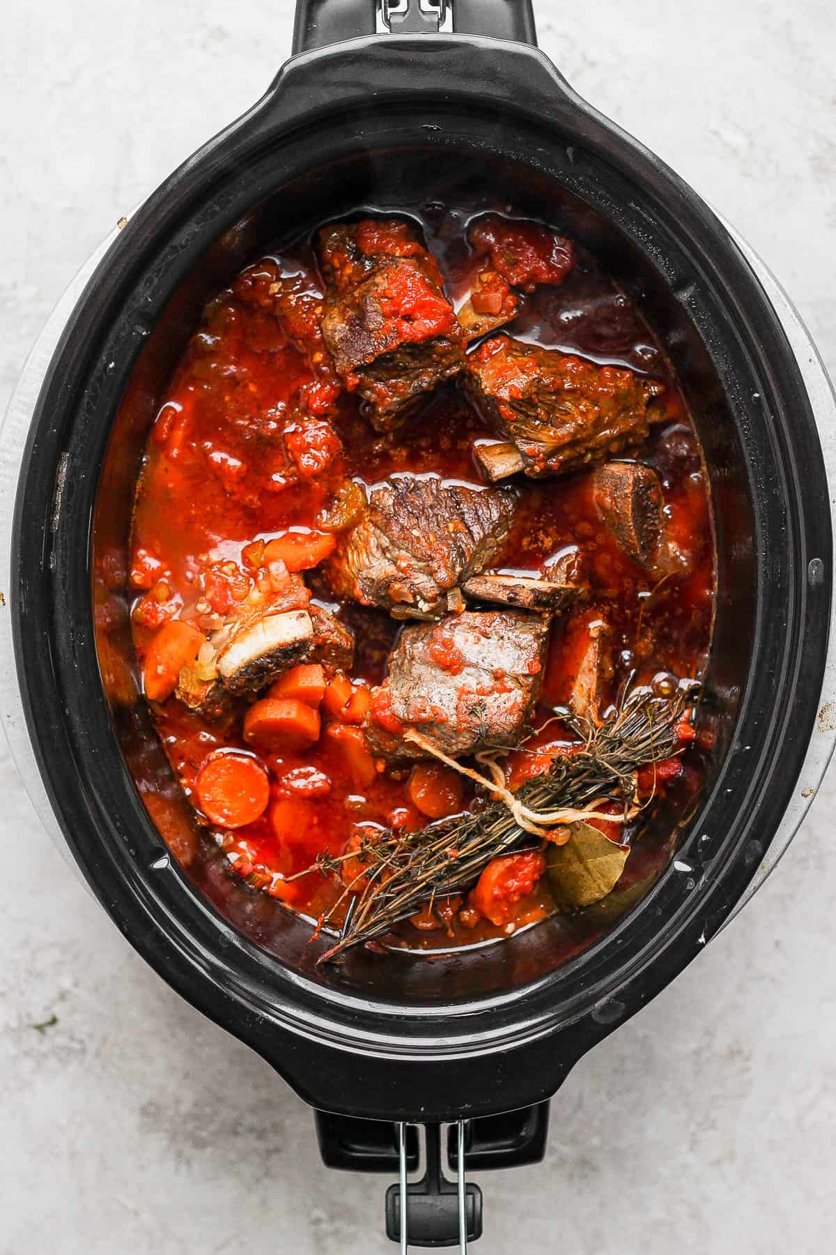After cooking in the slow cooker the short ribs are cooked in the marinara sauce.