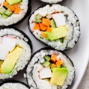 A plate of California roll sushi pieces.