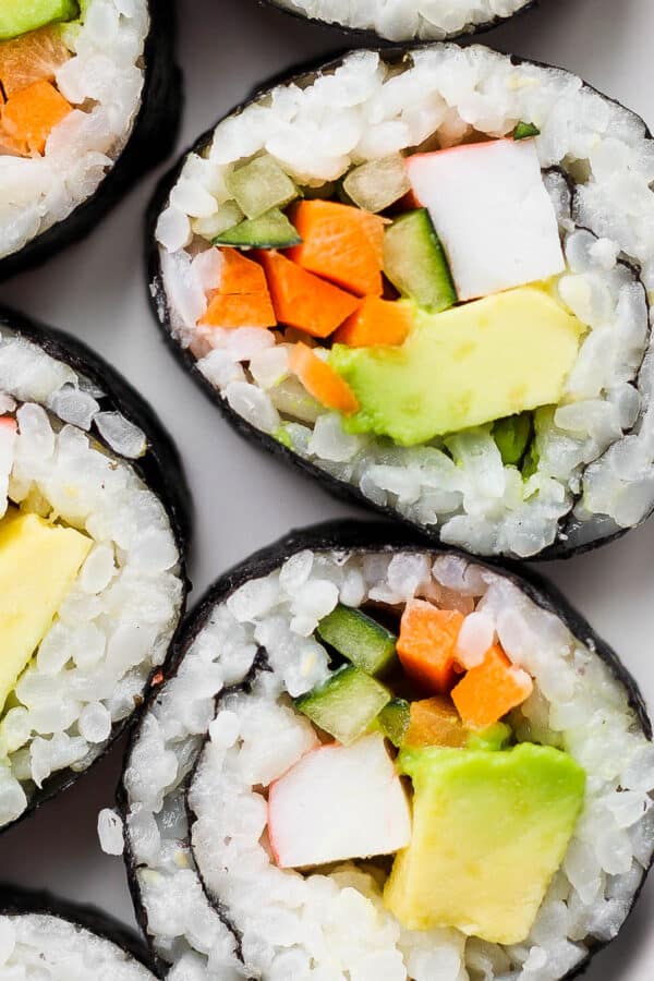 A plate of California roll sushi pieces.