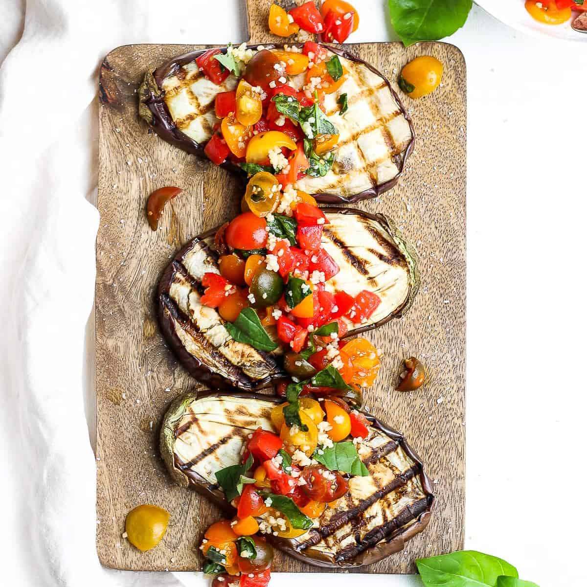 A platter of eggplant bruschetta with fresh tomatoes and garlic.