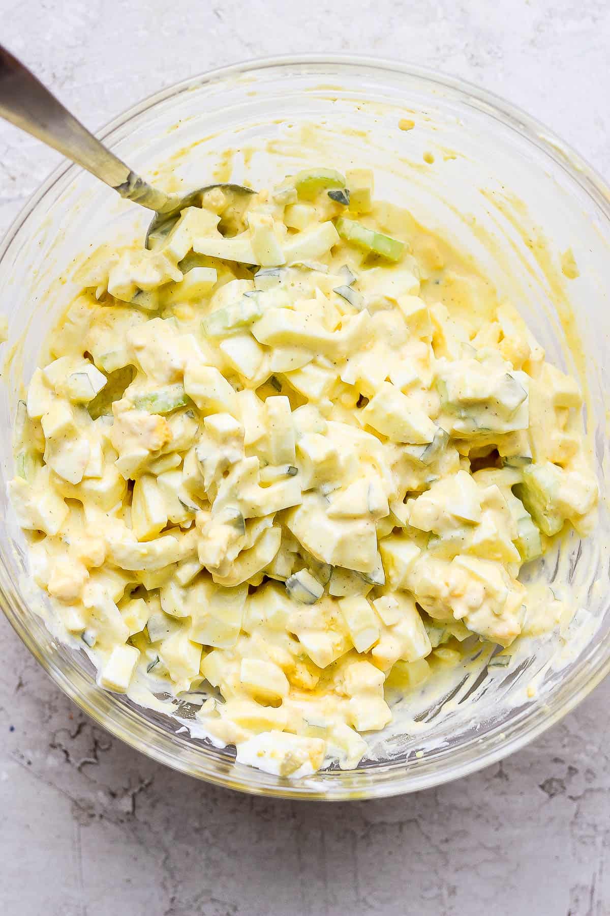 All of the egg salad ingredients mixed together in one bowl.