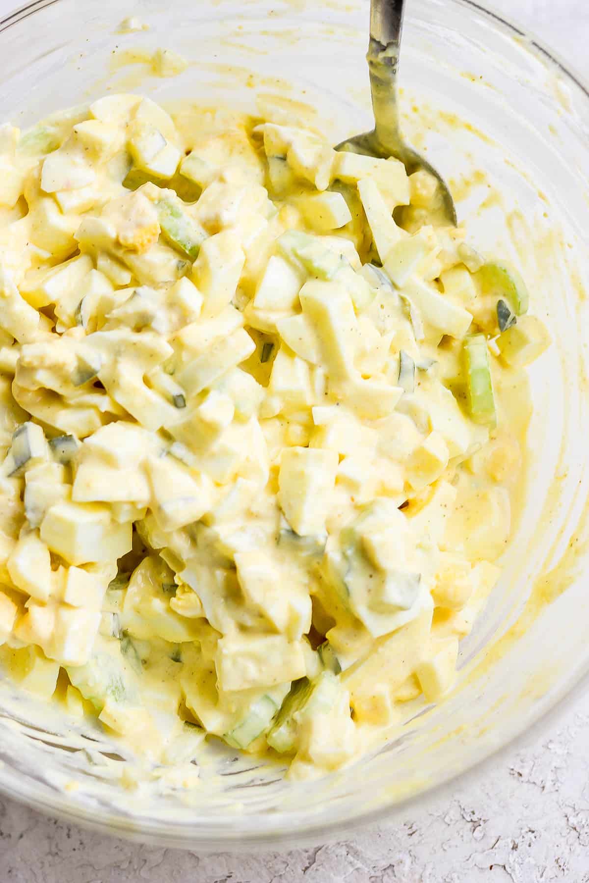 The best egg salad in a bowl with a spoon.