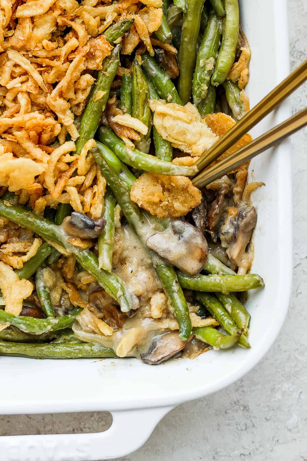 Two spoons in the green bean casserole.