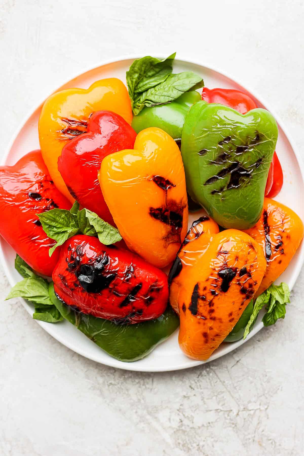 Grilled peppers on a white plate.