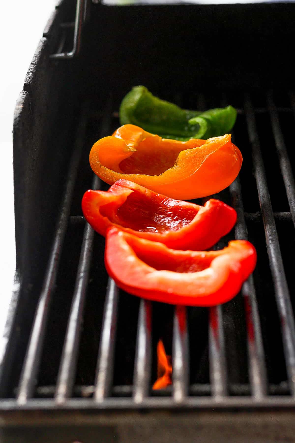 Bell pepper quarters on clean grill grates.