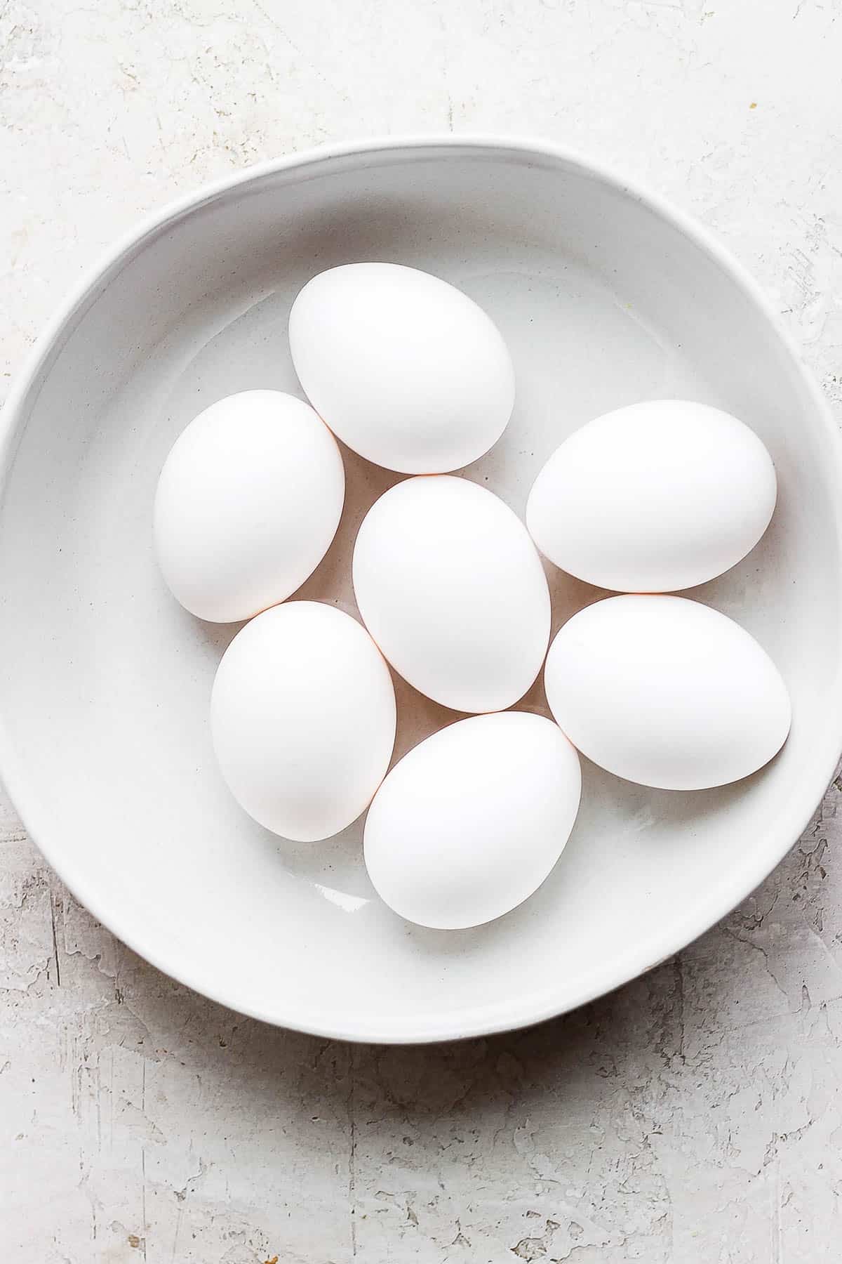 Six eggs in a shallow bowl.