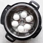 Top down shot of eggs in an Instant Pot held in an egg insert.