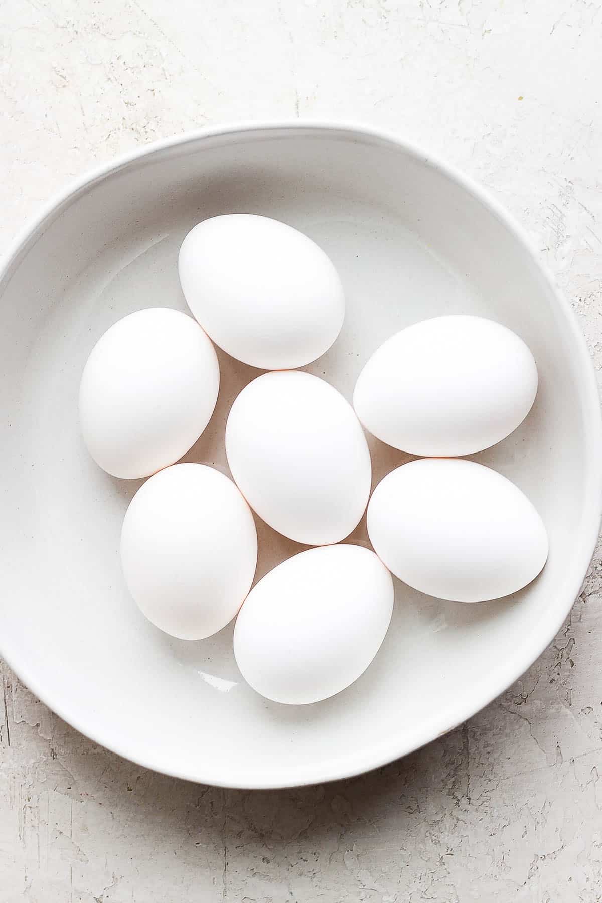 Seven eggs in a shallow bowl.
