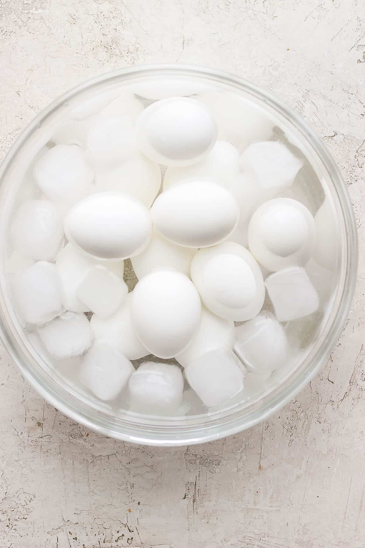 Twelve eggs in an ice bath.