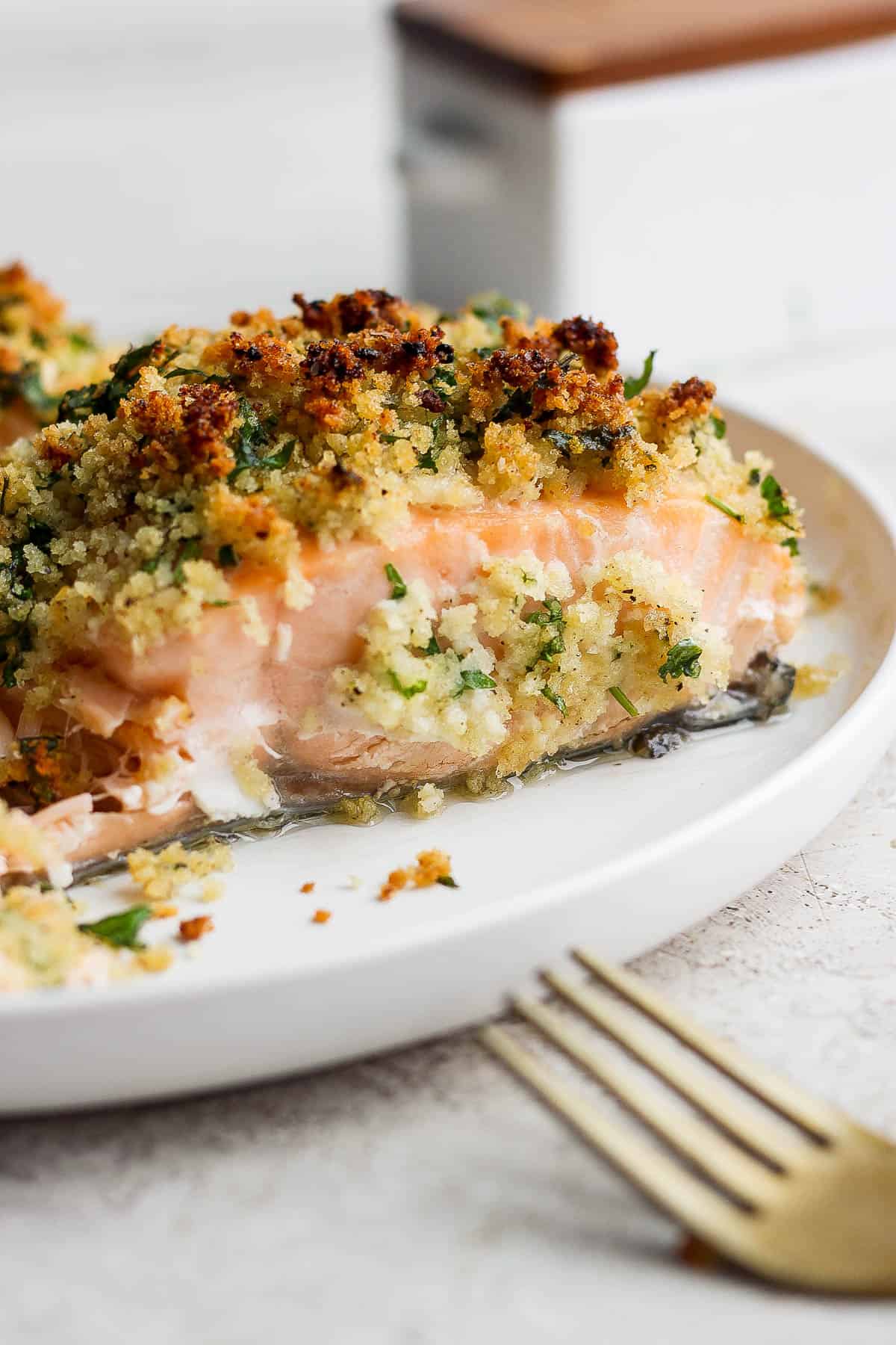 A panko crusted salmon fillet on a plate.