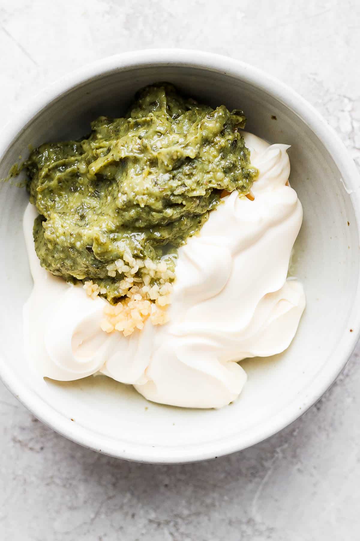 Pesto aioli ingredients in a medium mixing bowl.