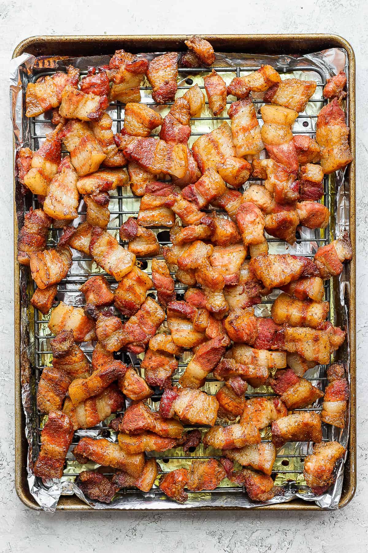 Smoked pork belly pieces on the wire rack after cooking for 2-3 hours.