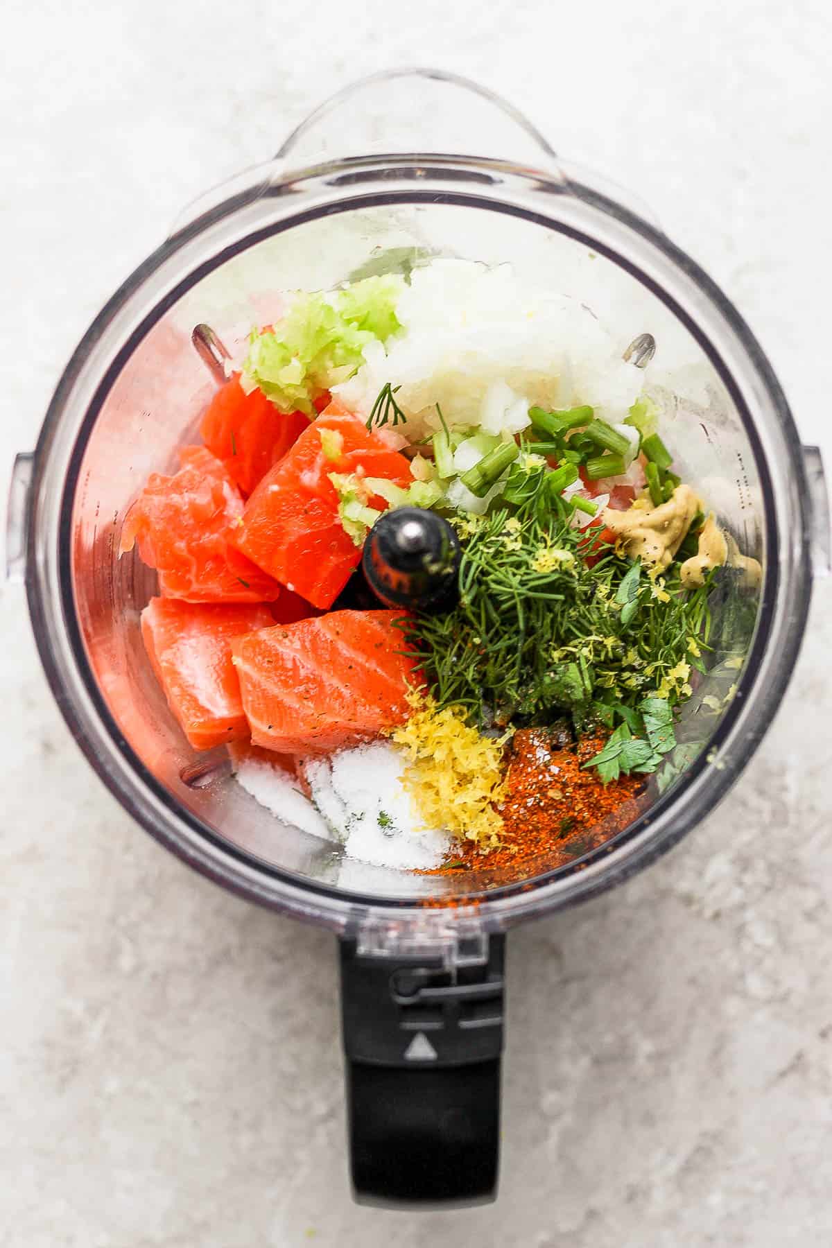 All of the burger ingredients in a food processor.