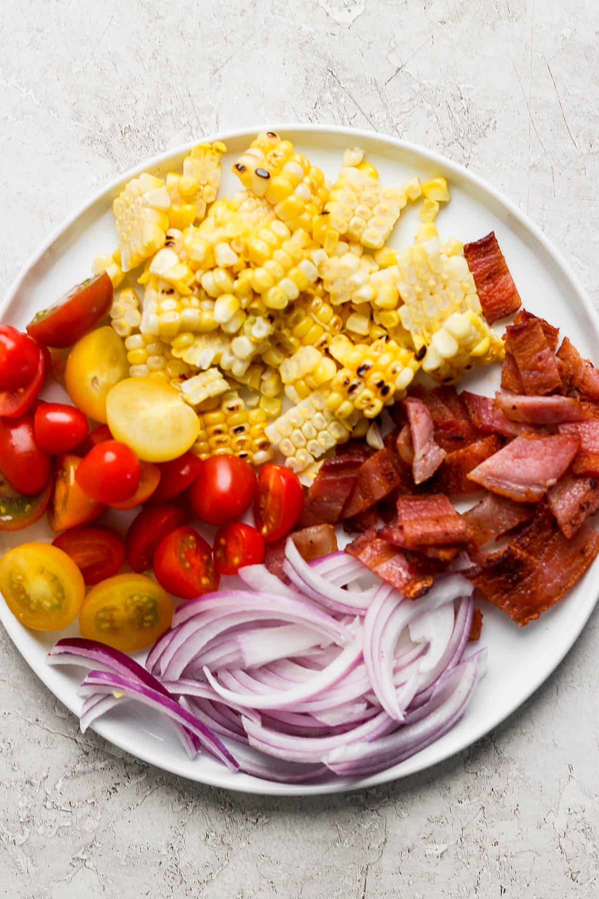 Salad toppings on a white plate.